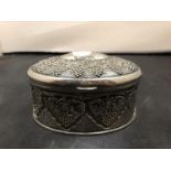 AN ORNATE OVAL METAL TRINKET BOX CONTAINING VARIOUS LADIES WRIST WATCHES