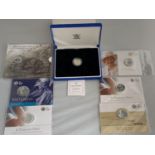 SEVEN VARIOUS SILVER PROOF COINS IN COMMEMORATIVE WALLETS
