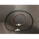 A BLACK LEATHER PANDORA NECKLACE 10.6" AND A BROWN LEATHER PANDORA BRACELET