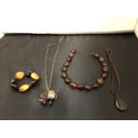 A POSSIBLY AMBER NECKLACE AND ELEPHANT PENDANT