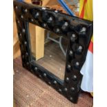 A LARGE SQUARE BLACK AND DIAMONTE FRAMED MIRROR