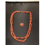 A CORAL DOUBLE ROW NECKLACE, LENGTH 47.2CM AND A VICTORIAN CORAL BROOCH