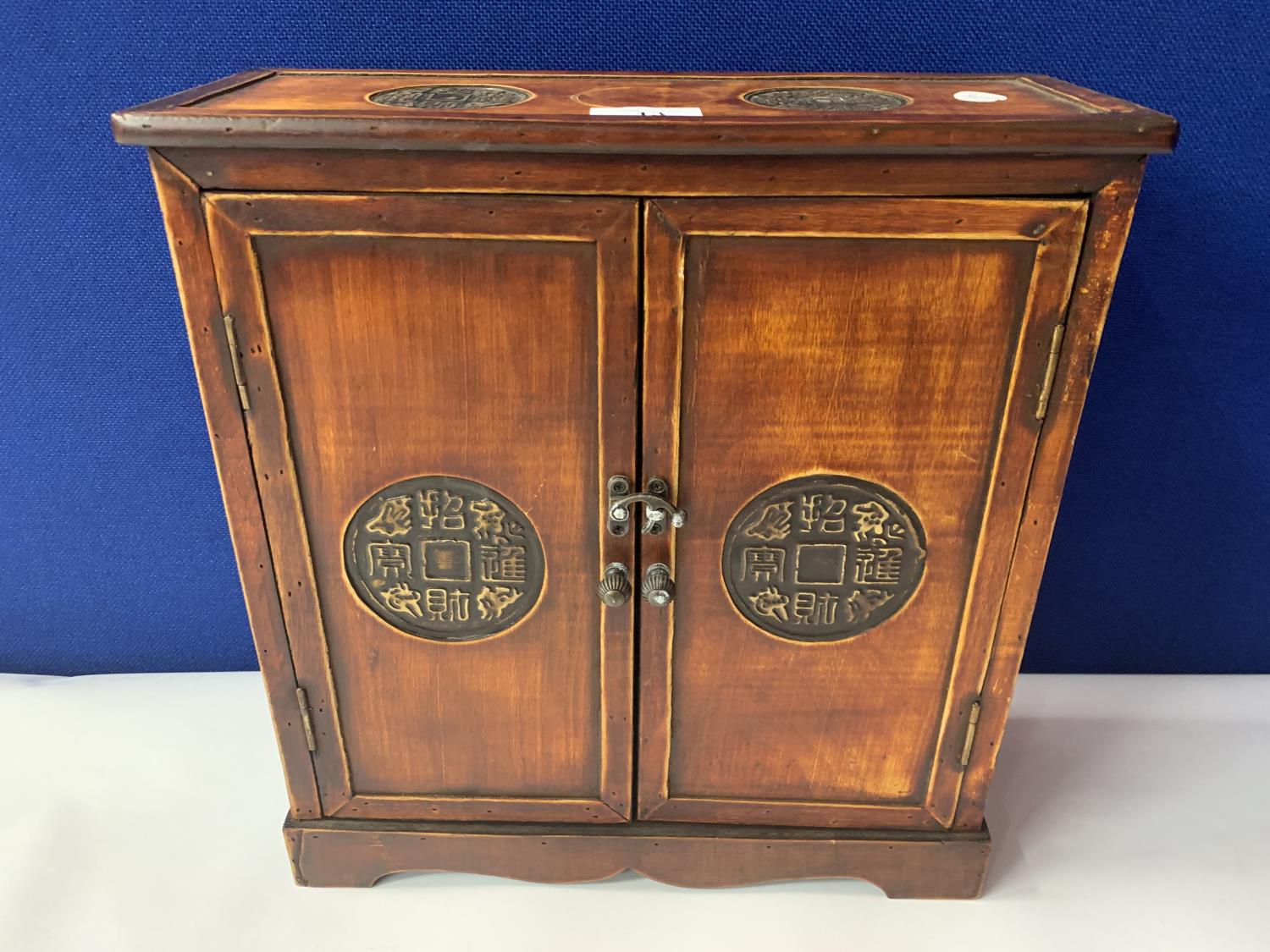 AN ORIENTAL STYLE CABINET WITH INLAID CIRCULAR PANELS