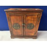 AN ORIENTAL STYLE CABINET WITH INLAID CIRCULAR PANELS