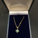 A FOUR STONE PERIDOT PENDANT ON A 9CT GOLD NECKLACE 2.3 GRAMS
