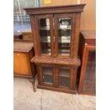 A VICTORIAN WALNUT GLAZED TWO DOOR BOOKCASE ON BASE WITH BEVELLED GLASS, 32" WIDE