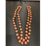 A CARVED NUT BEADED NECKLACE