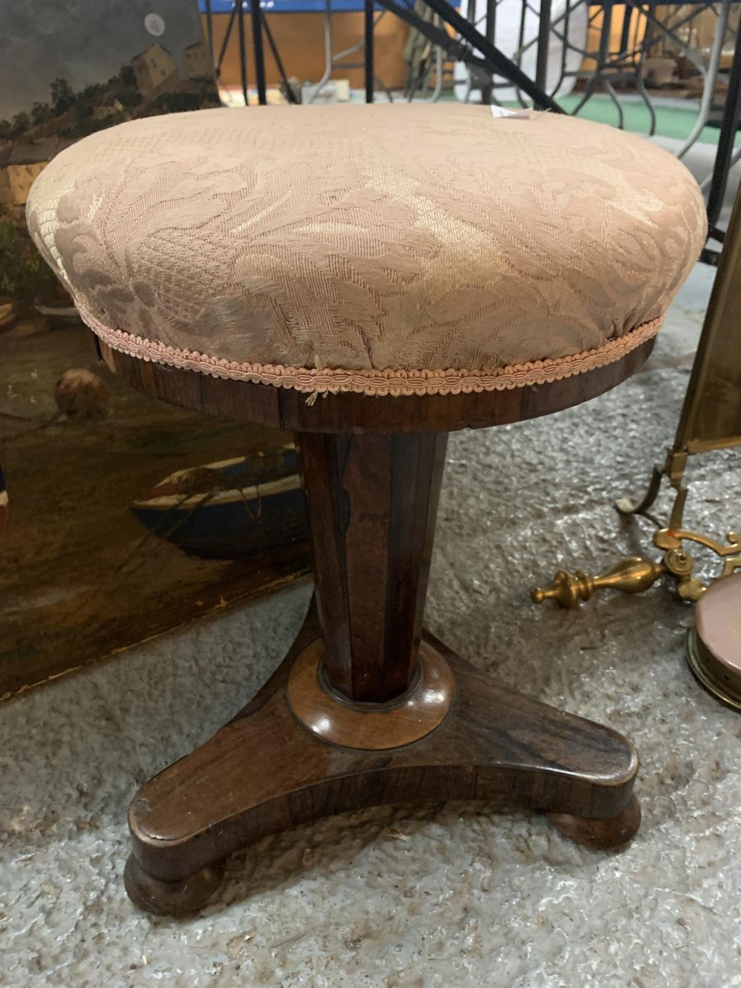 A VICTORIAN WALNUT ROTATING PIANO STOOL WITH AN UPHOLSTERED SEAT