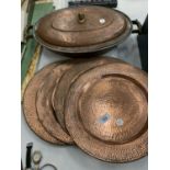 A LARGE BRASS LIDDED DISH AND FOUR BRASS PLATTERS