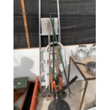 TWO SETS OF STEP LADDERS, GARDEN TOOLS AND A CAST METAL GARDEN UMBRELLA BASE