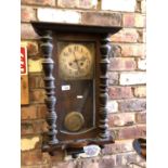 A VINTAGE ORNATE WOODEN WALL CLOCK