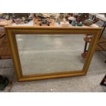 A LARGE GILT FRAMED RECTANGULAR MIRROR