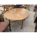 AN ERCOL EXTENDING DINING TABLE ON TAPERED LEGS AND SHAPED STRETCHERS, 64x43" (62.5"FULLY OPEN)