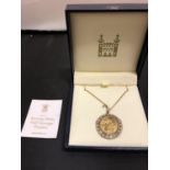 A ROYAL MINT BURNING FLAME HALF SOVEREIGN PENDANT SET IN A 9CT GOLD MOUNT WITH CHAIN 12.1 GRAMS