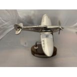 A CHROME MODEL OF A SPITFIRE ON A WOODEN BASE