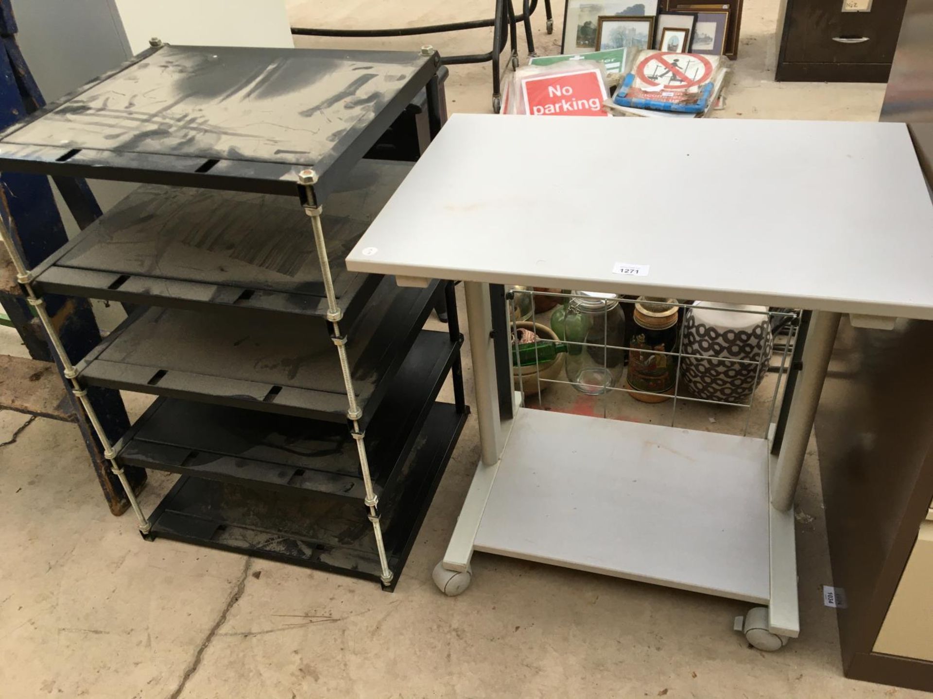A PLASTIC AND METAL COMPUTER TABLE AND A HEAVY METAL FOUR SHELF UNIT
