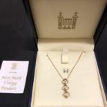 A ROYAL MINT 'MINT MARK TRILOGY PENDANT WITH THREE DIAMONDS SET IN A 18CT GOLD MOUNT WITH CHAIN 4.