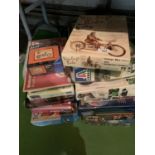 A LARGE QUANTITY OF MOTORCYCLE RELATED JIGSAWS AND MODEL MAKING KITS ETC