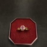 A 9CT GOLD RING SET WITH CENTRE PINK STONE AND SURROUNDING DIAMOND CHIPS 1.8 GRAMS