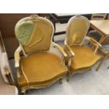 A PAIR OF CONTINENTAL CREAM AND GILT OPEN AIRMCHAIRS