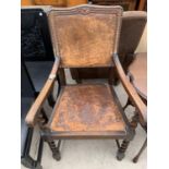 AN EARLY 20TH CENTURY OAK CARVER CHAIR WITH LEATHER STUDDED BACK AND PLAIN SEAT WITH BARLEYTWIST