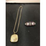 A ROLLED GOLD LOCKET AND A MICRO MOSAIC BAR BROOCH