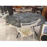 A LARGE METAL GARDEN TABLE WITH FOUR CHAIRS