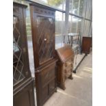 A JAYCEE OAK GLAZED AND LEADED DOUBLE CORNER CABINET, 34" WIDE