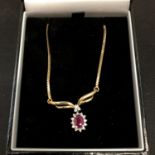 A RUBY PENDANT ON A 9CT GOLD NECKLACE 4.1 GRAMS (CHAIN BROKEN)