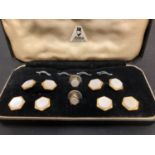 A MOTHER OF PEARL STUD SET