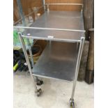 A TWO LEVEL STAINLESS STEEL CATERING TEA TROLLEY