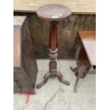 A VICTORIAN MAHOGANY TORCHERE ON TRIPOD BASE