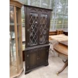 A JAYCEE OAK GLAZED AND LEADED DOUBLE CORNER CABINET, 34" WIDE