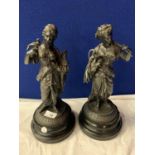 A PAIR OF SPELTER FIGURINES ON POLISHED SLATE BASES
