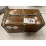 A WOODEN AND METAL BOUND VINTAGE MONEY BOX