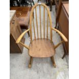 AN ERCOL ELM SEATED ARCH BACK CHILDS ROCKING CHAIR