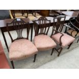 A GEORGE III MAHOGANY ELBOW CHAIR AND PAIR OF HEPPLEWHITE STYLE CHAIRS