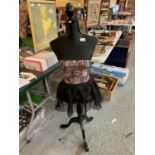 A BLACK MANNEQUIN WITH ANIMAL PRINT DRESS