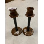 A PAIR OF TORTOISE SHELL EFFECT CANDLE STICKS