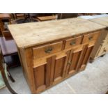 A VICTORIAN PINE KITCHEN DRESSER BASE ENCLOSING A CUPBOARD AND DRAWERS, 48" WIDE