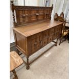 AN EARLY 20TH CENTURY OAK JACOBEAN STYLE SIDEBOARD ON BARLEYTWIST LEGS AND RAISED BACK, 60" WIDE