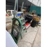 A RISING SUN PUB SIGN AND A SET OF STEP LADDERS