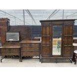 AN EARLY 20TH CENTURY JACOBEAN STYLE CARVED AND PANELED OAK THREE PIECE BEDROOM SUITE ON TURNED