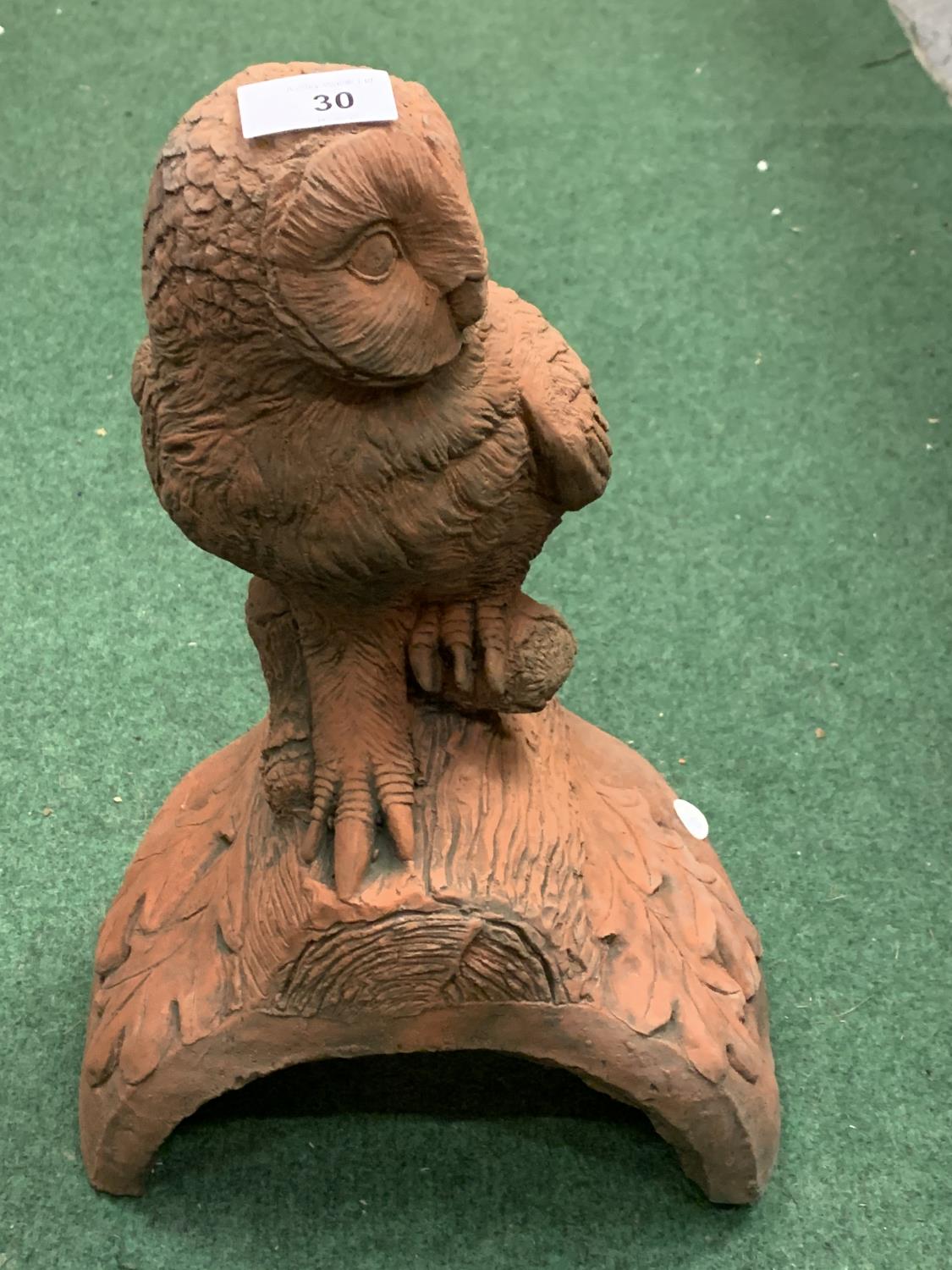 A TERRACOTTA ROOF FINIAL WITH OWL DETAIL