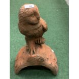 A TERRACOTTA ROOF FINIAL WITH OWL DETAIL