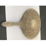 AN EDWARDIAN CONTINENTAL SILVER OVAL EMBOSSED HAND MIRROR