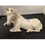 A BESWICK WHITE MODEL OF A HORSE LYING DOWN