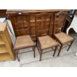 THREE EDWARDIAN MAHOGANY AND INLAID BEDROOM CHAIRS WITH CANE SEATS
