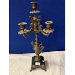AN ORNATE SPELTER FOUR CANDLESTICK MOUNTED ON A POLISHED SLATE BASE