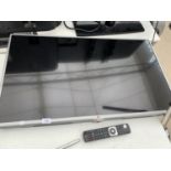 AN LG 43 INCH LCD TELEVISION TO INCLUDE A STAND AND REMOTE CONTROL